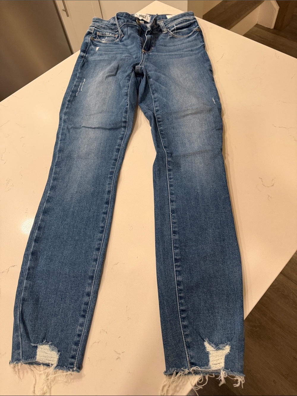 PAIGE Light Blue Skinny Jeans with Distressed Raw Hems